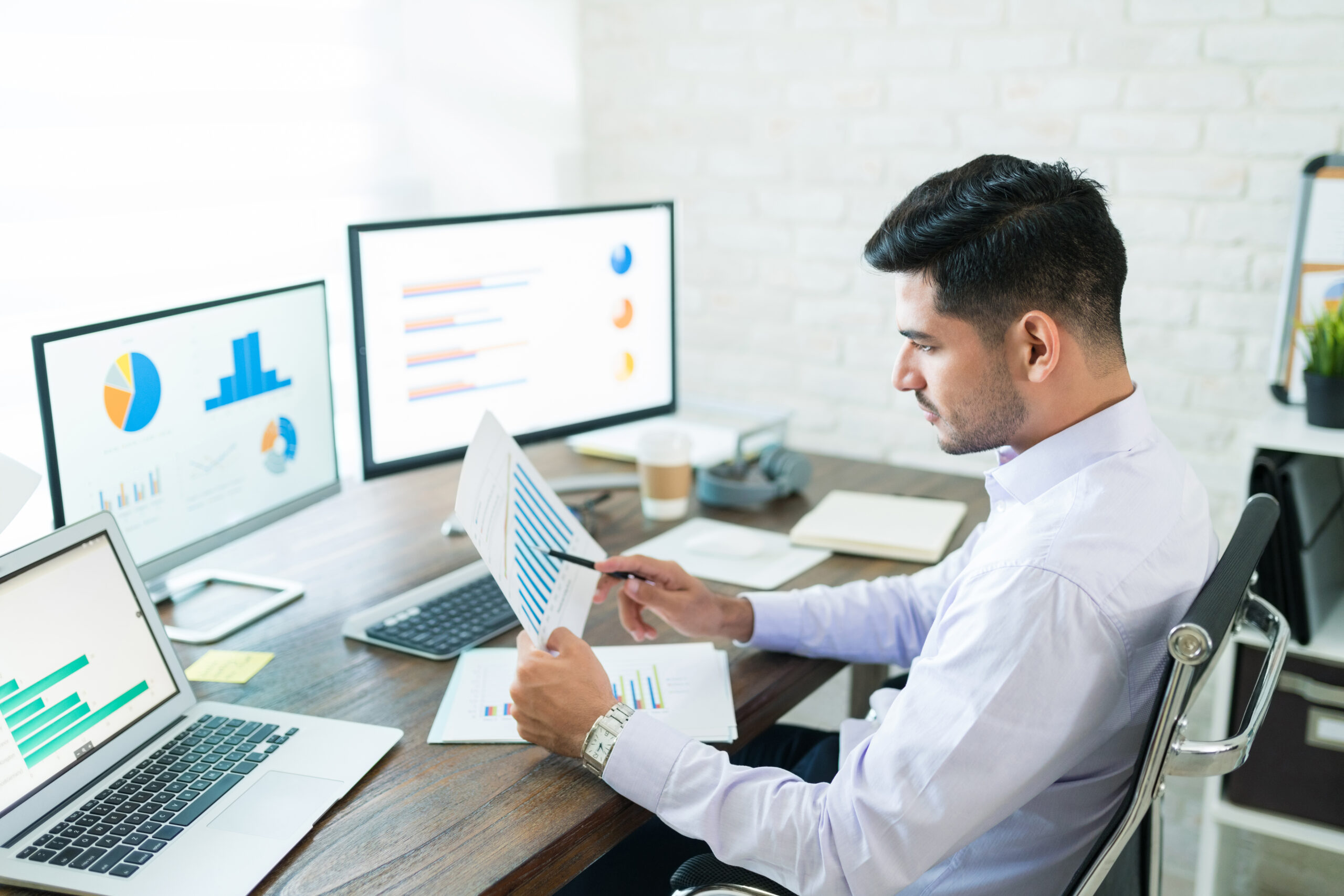 attractive young male sales professional analyzing chart